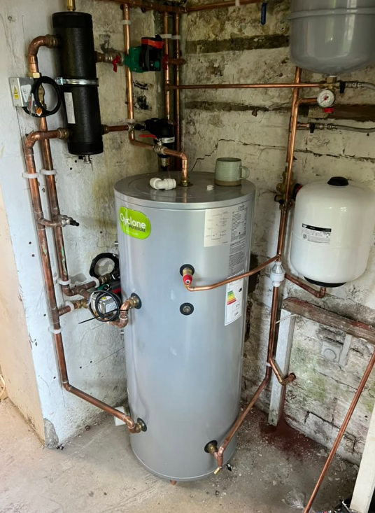 Cyclone hot-water cylinder with surrounding copper pipework, circulation pump, valves and expansion vessels