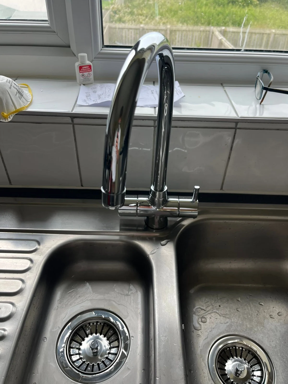 Stainless-steel kitchen sink with a fitted chrome mixer tap